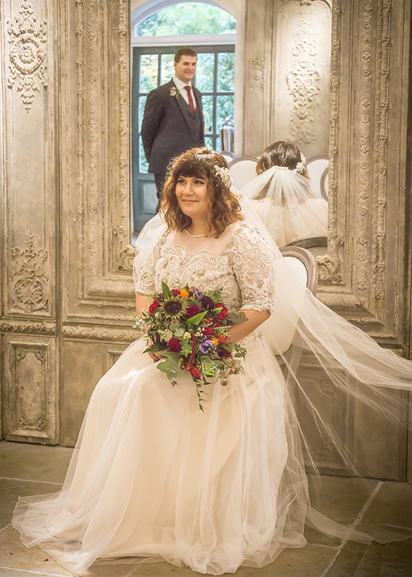 bride sitting groom mirror