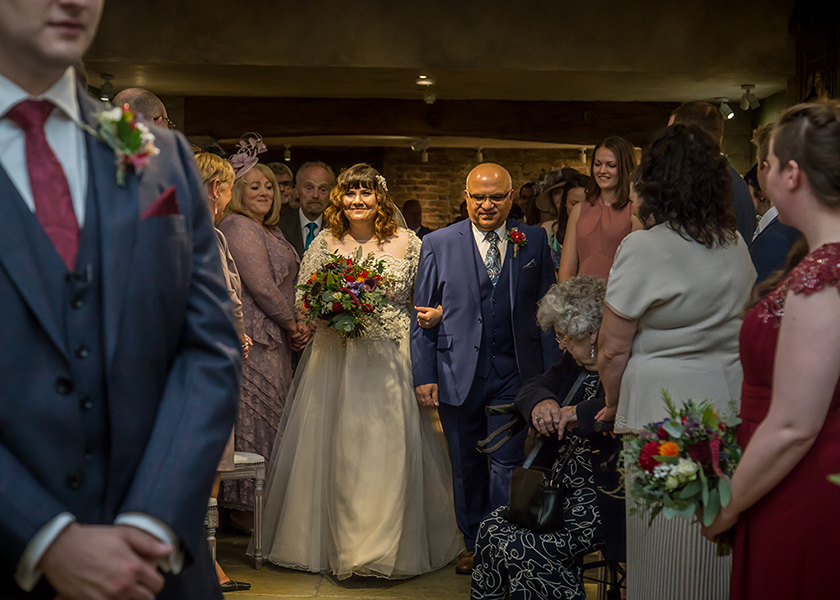 bride walking aisle with father