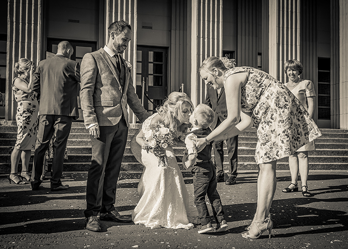 bride receiving lucky horseshoe from boy