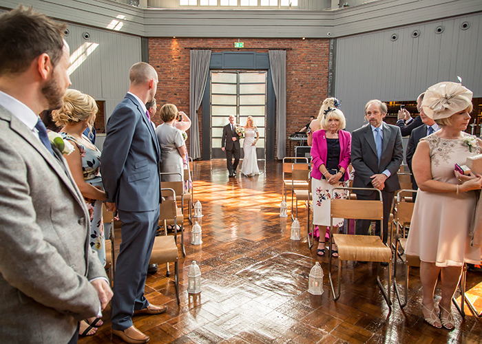 bride walking down aisle with father