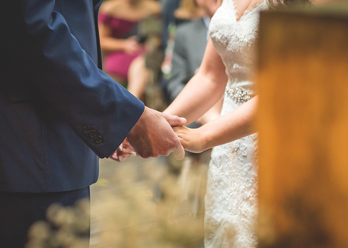 wedding service holding hands