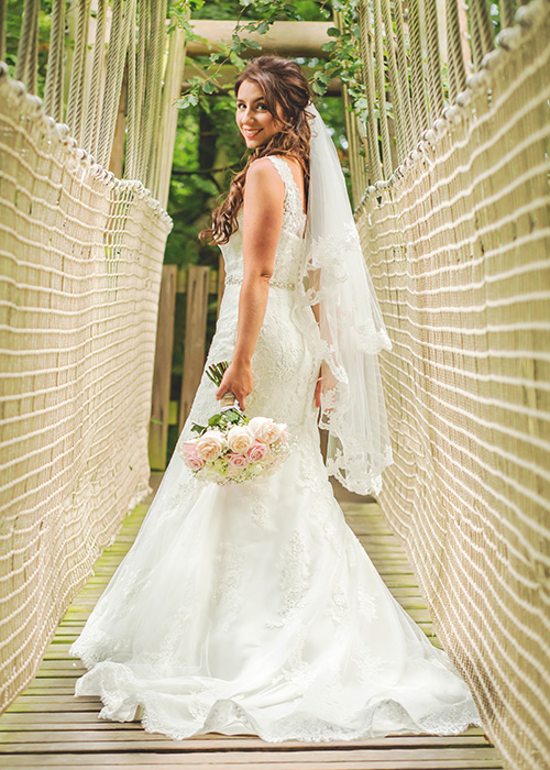 alnwick treehouse wedding photo of bride on rope bridge