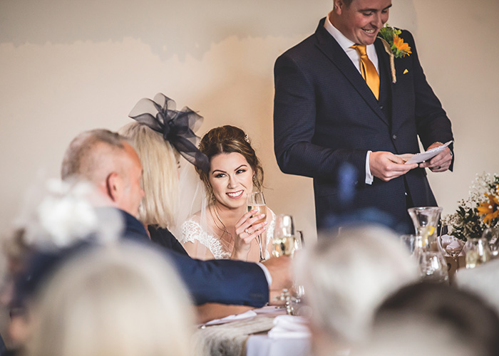 bride laughing at grooms speech