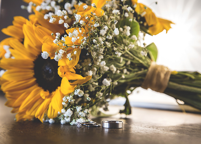 wedding rings with sunflower bouquets