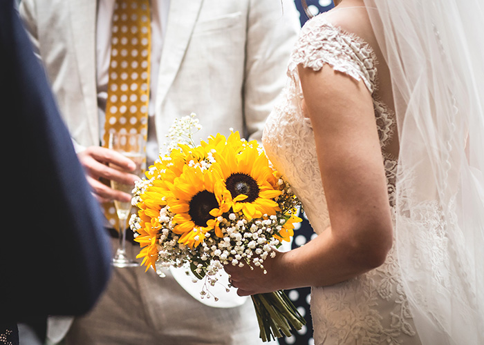 bride with stunning yellow sunflower bouquet