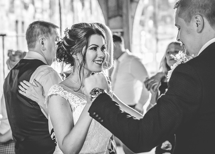 brid and groom dancing with guests