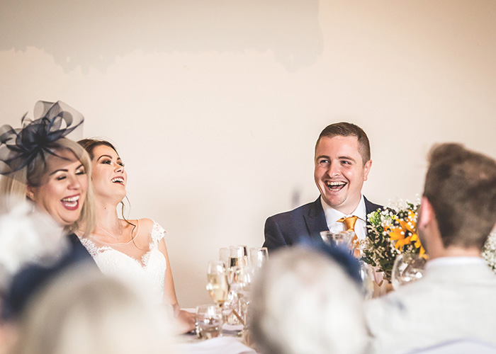 family laughing at father of the brides speech