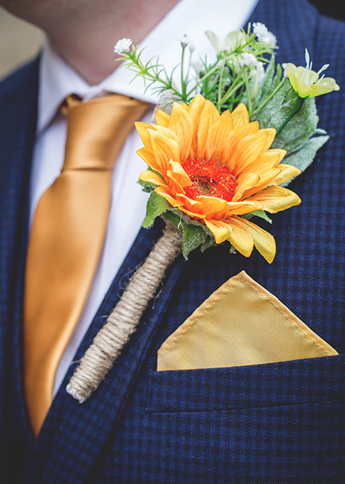 sunflower buttonhole yellow with blue suit