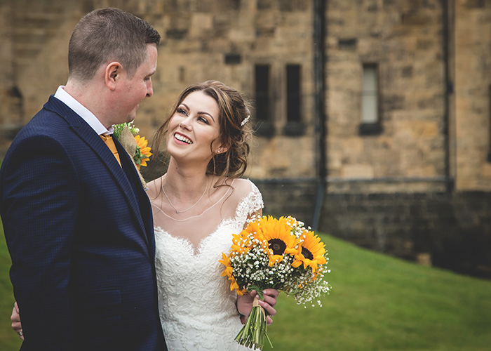 happy couple with sunflower bouquet